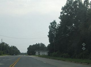 NC 24/27 carry five overall lanes from Biscoe into its outlying area. This set of shields are posted after the intersection with Coggins Road. Further west the highway widens to four lanes with a grassy median. The stretch of road is known as the Bob Jordan Highway.