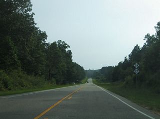Liberty Hill Church Road north and Wadeville Road (SR 1134) come together at NC 24/27 before this shield assembly.