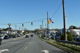 U.S. 29/74 (Wilkinson Boulevard) span a Norfolk Southern Railroad line ahead of the signalized intersection with Groves Street (SR 2213) north to 1st Street in Lowell.