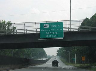 U.S. 29-220 south converge with I-40 at Martin Luther King Jr. Drive (former U.S. 421). Prior to September 2008, U.S. 421 branched south from I-40 along J.M. Hunt, Jr. Expressway toward Julian.