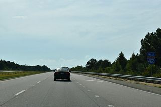 Leading away from the exchange with U.S. 70/70 Business near Powhatan along the Clayton Bypass.