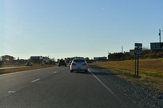 Dr. Donnie H. Jones, Jr. Boulevard (SR 2556) returns to U.S. 70 at the east end of the Princeton bypass.