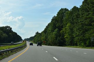 U.S. 70 confirming marker posted along the expressway westbound between the Buffalo Road entrance ramp and RIRO intersection with W Oak Street (SR 1929).