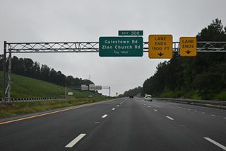 Two lanes from I-74 east converge with two lanes from U.S. 74 east 0.75 miles ahead of Exit 308.
