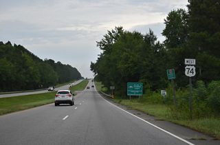 I-74/U.S. 74 travel 1.52 miles west through timberland from the Scotland County line to Exit 321.