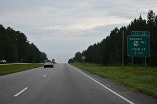 U.S. 74 Business west commences from a wye interchange at Exit 321.