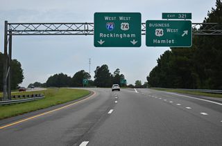 I-74/U.S. 74 bypass Hamlet and Rockingham to the south. U.S. 74 Business constitutes a 14.56 mile long loop from Steen Town near Exit 321 to Exit 306 west of Piney Grove.