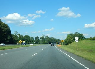 U.S. 74 Business (Ellenboro Road) from Forest City and Ellenboro converges with U.S. 74 (Dixon Boulevard) at a wye intersection preceding Academy Street south into Mooresboro. This reassurance marker was removed by 2020.