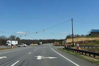 Academy Street north intersects U.S. 74 (Dixon Boulevard) across from Lattimore Road (SR 1168) southwest from the town of Lattimore. The U.S. 74 Improvements Project (R-4045) builds a parclo interchange joining both the east end of U.S. 74 Business and Lattimore Road with U.S. 74.