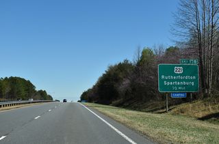 U.S. 221 converges with the U.S. 74 freeway six miles to the south of Rutherfordton. U.S. 221 provides the main route between the Rutherford County seat and the city of Spartanburg, South Carolina, located 28 miles to the south.