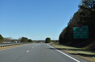 A diamond interchange joins U.S. 74 and 221 at Exit 178. U.S. 221 follows Main Street through Forest Hills and Downtown Rutherfordton, where the route meets NC 108/U.S. 74 Business (Charlotte Road).