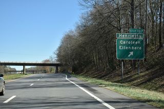 Another abandoned branch of the CSX Railroad passes over U.S. 74 ahead of Exit 187 to Ellenboro Henrietta Road (SR 1920). The rural highway travels 2.7 miles south to U.S. 221A at Avondale near both Caroleen and Henrietta. Northward SR 1920 becomes Henrietta Street to U.S. 74 Business (Main Street) in Ellenboro.