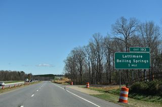 Section AA of the U.S. 74 Shelby Bypass included upgrading U.S. 74 along Dixon Boulevard to a freeway east of Sandy Run. Work from July 2013 to September 2016 replaced the at-grade intersection with Peachtree Road north and McBrayer Homestead Road south with a folded diamond interchange (Exit 193).