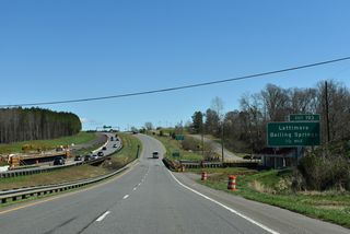 The U.S. 74 Improvements Project (R-4045) replaces the 1925-built bridge eastbound and a 1965-bridge westbound over Sandy Run (NCDOT, 2026). Both spans were rehabilitated in 1999. Exit 193 follows in a half mile for McBrayer Homestead Road (SR 1162) south to the town of Boiling Springs and Gardner Webb University.