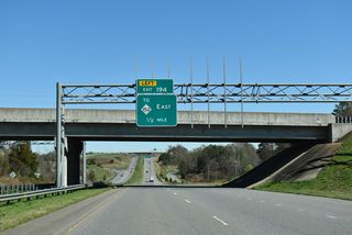 Section AA construction of the Shelby Bypass included a realignment of U.S. 74 northward to accommodate a new trumpet interchange with Dixon Boulevard at Swainsville. The former alignment along Sunset Boulevard acts as a service road to the south.