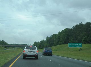 The next three interchanges serve Kings Mountain from the north. Oak Grove Road (SR 2033) stems north from Waco Road to a diamond interchange with U.S. 74. SR 2033 arcs northwest to Moss Lake.