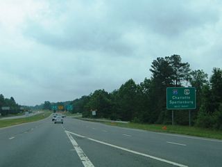 Traffic from King Street merges onto U.S. 74 east, with four lanes advanceing east to a ramp split for I- 85 and U.S. 29 south and the continuation of U.S. 29/74 east (Kings Mountain Highway) into Gastonia.