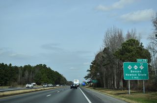 Interstate 95 converges with NC 50/242 through eastern reaches of the Benson town limits. NC 50/242 overlap 0.71 miles from the northbound off-ramp at Exit 79 to U.S. 301 (Wall Street) in Downtown Benson.