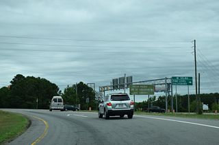Leading three miles east to Pine Level, U.S. 70 Alternate separates from U.S. 70 nearby ahead of Eastfield shopping center.