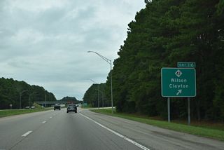 Exit 116 leaves Interstate 95 north for NC 42. The state route converges with I-587/795-U.S. 264 two miles to the east in the rural outskirts of Wilson.
