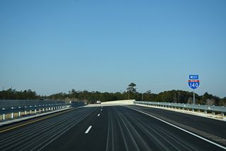 Interstate 140 makes a sweeping curve southwest to suburban areas of Leland. The freeway crosses over a CSX Railroad line by this confirming marker.