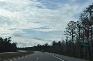 Distance sign posted 34 miles from Shallotte and 64 miles from Myrtle Beach, South Carolina.