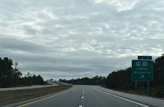 With the CSX Railroad to the immediate south, a folded diamond interchange connects I-140 with U.S. 74/76 at Exit 5. U.S. 74 follows the Future I-74 corridor northwest to Lumberton, Laurinburg and Rockingham.