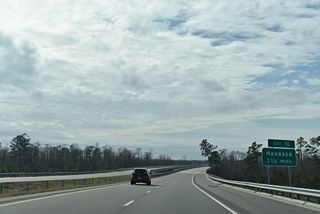 A series of four bridges cross over railroad spurs west of U.S. 421 and south of the Duke Energy Sutton Steam Plant.