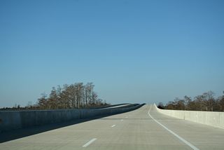 I-140 crests over the Cape Fear River a half mile east of the parclo interchange with Cedar Hill Road (SR 1430).