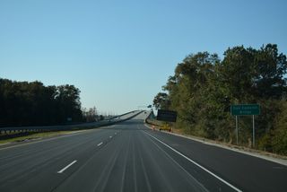 Interstate 140 curves southwest to cross the Northeast Cape Fear River over the Dan Cameron Bridge. This section of freeway opened to traffic on June 30, 2006.