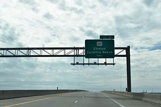 U.S. 421 originates south of Carolina Beach on the Atlantic Coast and travels north through Wilmington, overlapping with U.S. 17/76 across the Cape Fear River. Outside of the Wilmington area, U.S. 421 navigates along a rural route northwest to Wards Corner and Clinton.