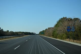 The first shield for Interstate 140 westbound stands beyond the U.S. 117/NC 132 (College Road) overpass. There is no direct access between the Wilmington Bypass and College Road.