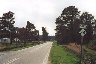 Looking at what was the first northbound NC 34 reassurance shield, posted a short distance from the Pasquotank River shoreline at Aline Drive. A begin shield for NC 344 stands here now.