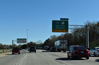 Interstate 485 advances southeast to Pineville and Weddington beyond Exit 67. I-77/U.S. 21 continue south two miles to split beyond the state line. Both routes head to Columbia, South Carolina.