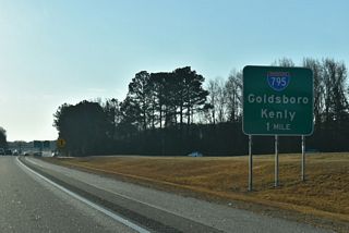 Interstate 795 south splits with I-587/U.S. 264 east at a wye interchange (Exit 23) 0.60 miles beyond the Downing Street entrance ramp.