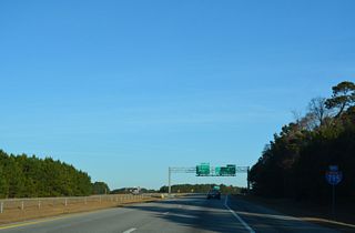End Interstate 795 shield posted at the exchange with I-95. Future I-587 accompanies U.S. 264 west to U.S. 64/Future I-87 at Zebulon.
