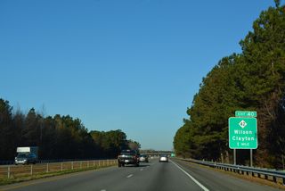 A folded diamond interchange (Exit 20) joins I-795/587-U.S. 264 west with NC 42 just beyond Contentnea Creek in one mile.