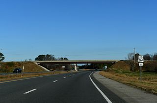 Interstate 795 defaults onto I-587/U.S. 264 westbound via a wye interchange just beyond Exit 5. The I-795 reassurance marker accompanying this U.S. 264 trailblazer was removed in 2024.