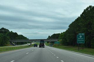 NC 42 meanders east from U.S. 70 in Clayton to meet I-587/795-U.S. 264 at a diamond interchange (Exit 20) in one mile.