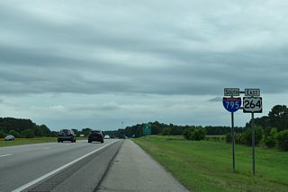 The first shield for I-795 south appears beyond the Old Raleigh Road (SR 1136) overpass. U.S. 264 around Wilson is designated the Governor James B. Hunt, Jr. Highway.