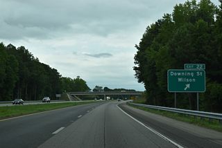 Exit 22 loops away from I-587/795 east for Downing Street. SR 1163 is rural east to Forest Hills Road (SR 1165). Connections with local roads lead west to Scotts and Lamms Crossroads along Wiggins Mill Road (SR 1103).