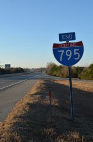 The freeway extends beyond the end shield for I-795 as NC 581 Connector for 0.62 miles to NC 581 (W Ash Street).