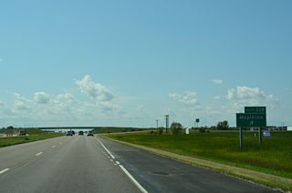 163rd Avenue SE heads north from I-94/U.S. 52 into Mapleton and south from the diamond interchange at Exit 338 to agricultural areas.