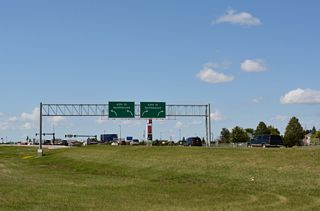 Entering the six-ramp parclo interchange with 45th Street. 45th Street comprises a commuter route south into newly developed areas, including the Urban Plains, Osgood, Woodhaven and The District neighborhoods, to 52nd Avenue South.