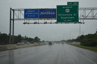 The North Dakota welcome sign appears a half mile ahead of Exit 351 to U.S. 81 Business (University Drive). U.S. 81 Business comprises a 10.84 mile long loop east through Fargo from I-29/U.S. 81 to the west.