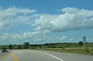 Business Loop I-94 west overtakes Old U.S. 10/52 north from Wolski Plaza Road.