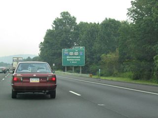 Signs for Interstate 287 reference the connections with U.S. 202/206 south into Somerville and I-80 to the north. U.S. 202/206 parallel I-287 through Pluckemin.