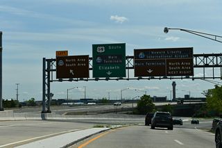 The eastbound ramp from Exit 57 to EWR Airport joins the distributor roadway extending south from a trumpet interchange with Interstate 78. A loop ramp follows onto the east end of U.S. 22 ahead of U.S. 1/9 north.