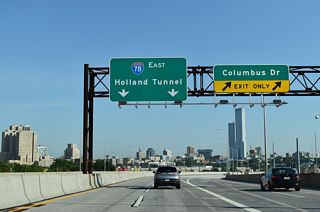 The unnumbered exit to Columbus Drive parts ways with I-78 east. Montgomery Street parallels Columbus Drive three blocks to the south toward the Hudson River. West of I-78, Montgomery Street continues to McGinley Square.