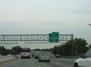 Interstate 80 spans the Passaic River into Bergen County and the borough of Elmwood Park ahead of the parclo interchange (Exit 61) with County Route 507 (River Drive).